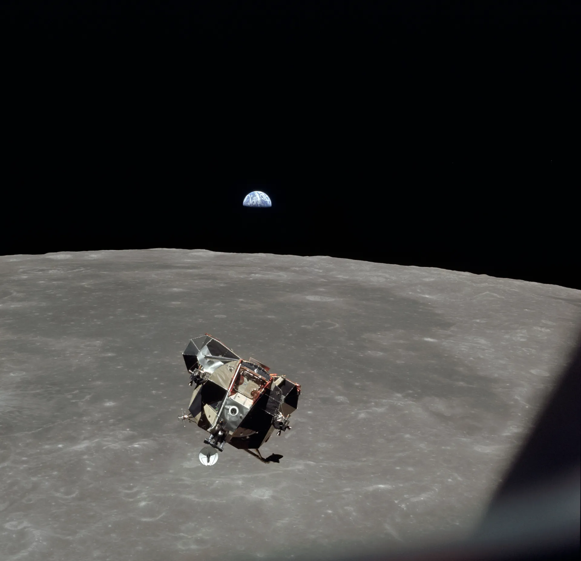 The Apollo 11 lunar module Eagle rises from the Moon to meet Columbia, with Earth beyond.