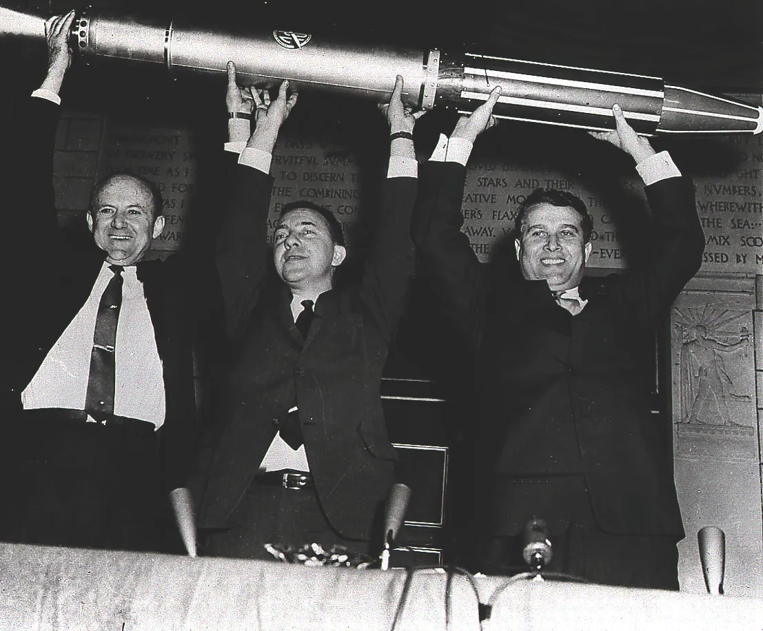 William Pickering, James Van Allen and Wernher von Braun hold up a model of Explorer 1 after its launch.