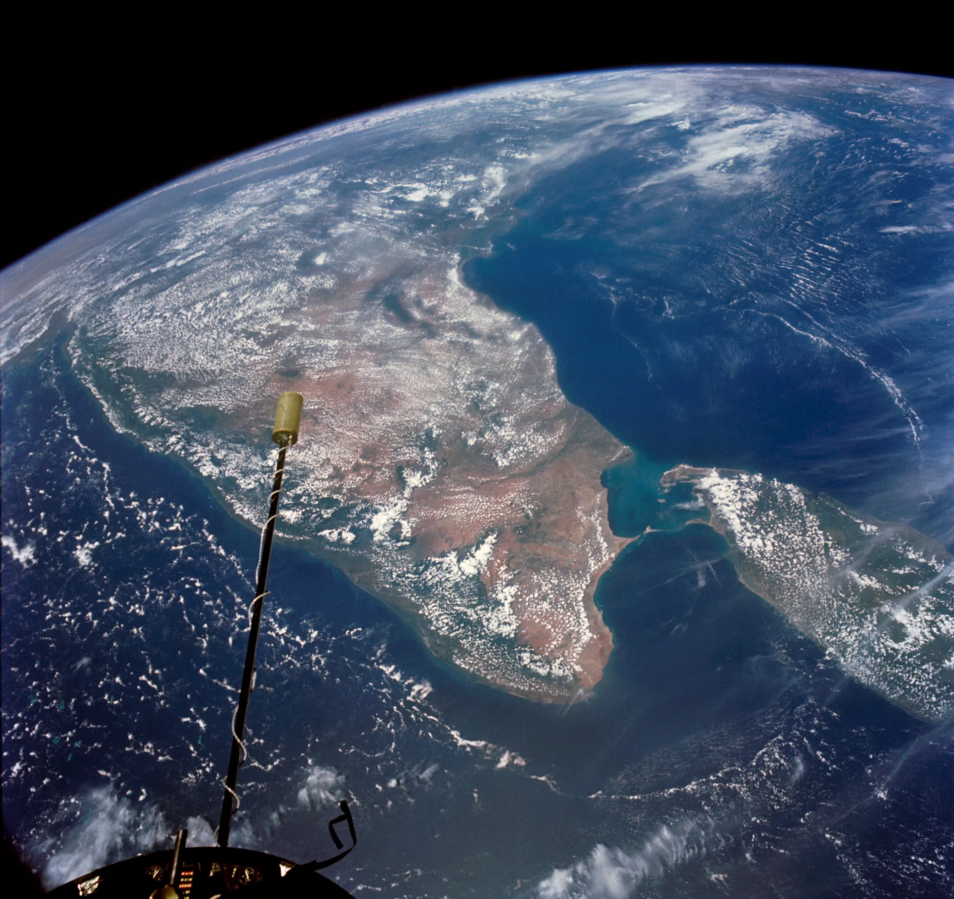India and Sri Lanka seen from high orbit, with Earth’s curve against black space.