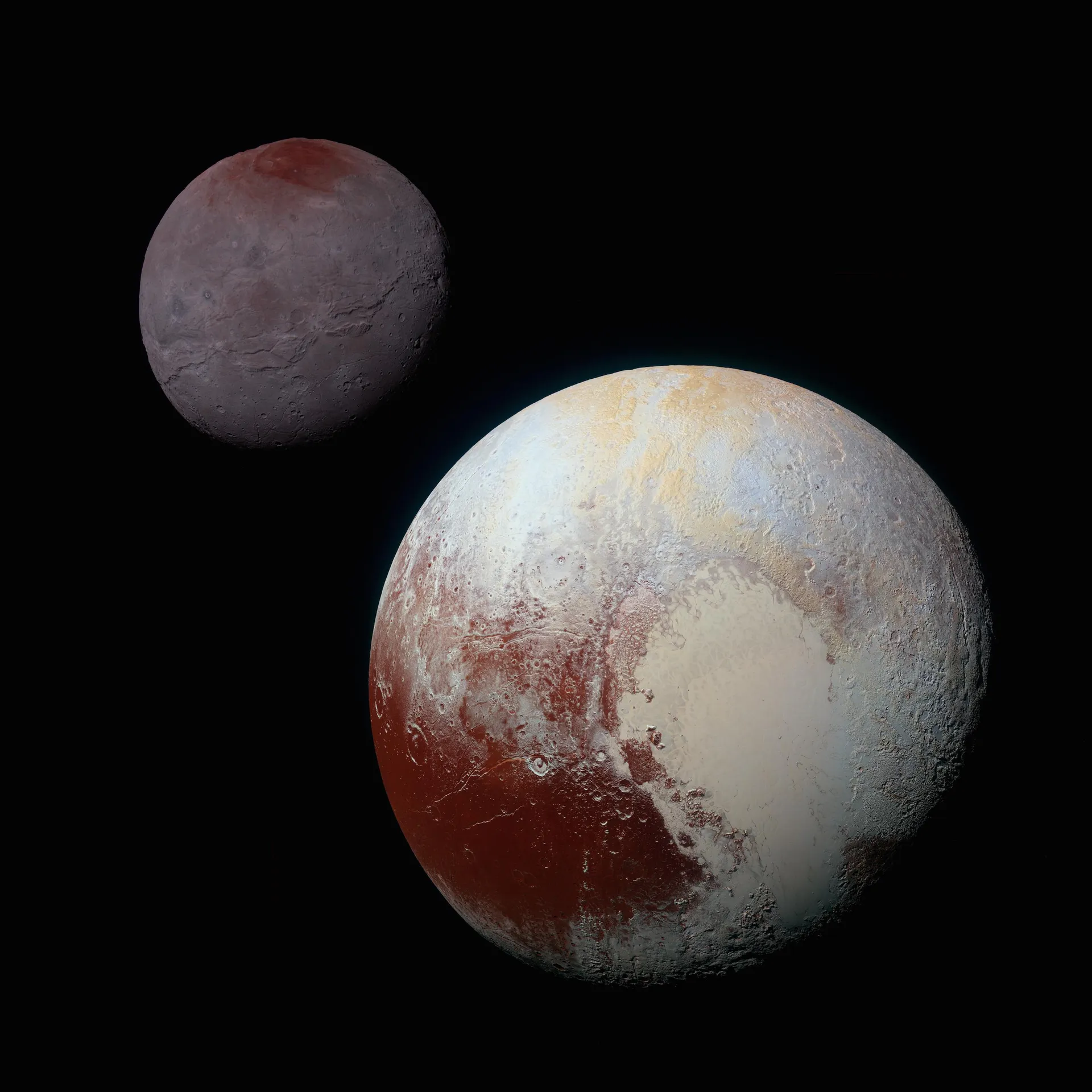 Two worlds against black space: the larger, Pluto, at lower right with a bright heart-shaped plain and dark red regions; the smaller, gray Charon, at upper left.